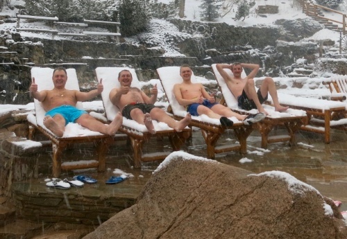 Russians on the snow covered deck chairs