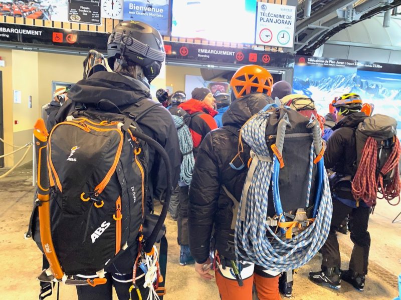 Serious mountain folk with huge back packs, coils of climbing rope and wearing helmets