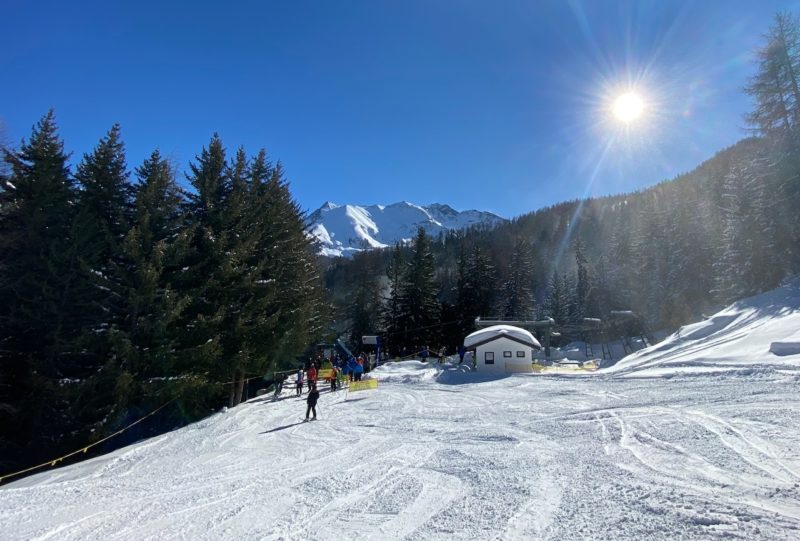 snow on ski slopes sun beating down